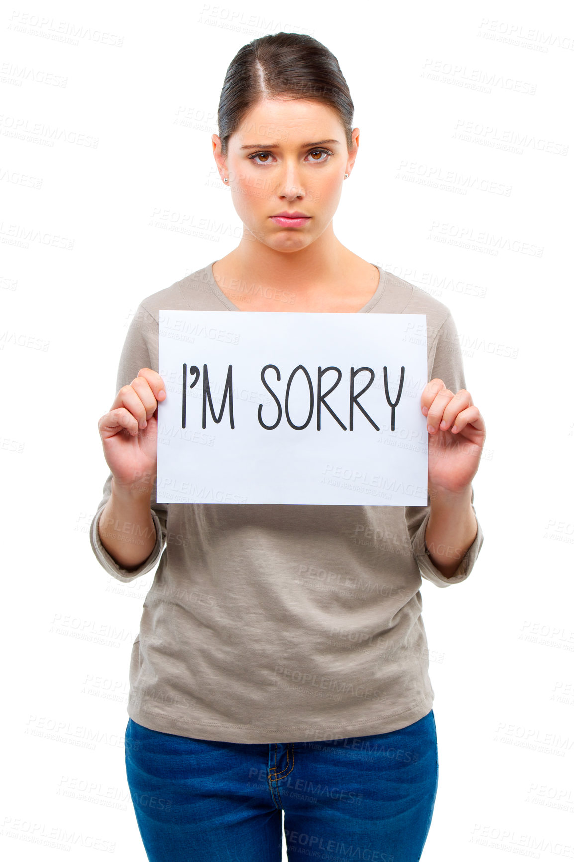 Buy stock photo A young woman holding a board with the words 'I'm sorry'
