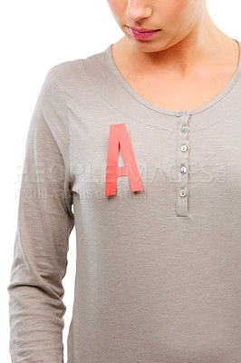 Buy stock photo Studio shot of a young woman with a red A on her top