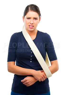 Buy stock photo Studio shot of a young woman with her arm in a sling isolated on white