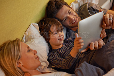 Buy stock photo Bed, parents or child with tablet for streaming, playing games or watching videos on movie website in home. Social media, happy kid or mom with dad or technology to download on ebook online at night