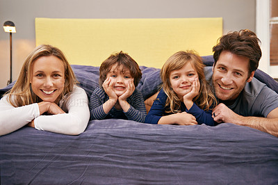 Buy stock photo Home, parents and kids portrait in bed with love, support and bonding together with a smile. Happy, family and children with mom in the morning in bedroom relax with youth in a house with parenting