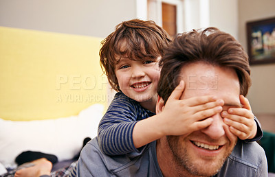 Buy stock photo Shot of a little boy covering his father's eyes with his hands