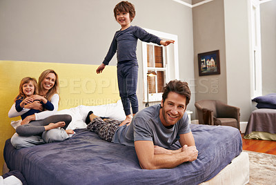 Buy stock photo Home, parents and kids fun on bed with love, support and bonding together with a smile. Happy, family and children with mom in the morning in the bedroom play with sibling in a house with parenting