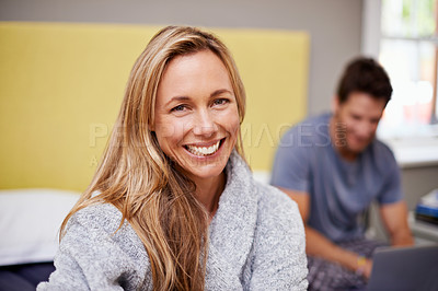 Buy stock photo Woman, smile and portrait with partner, bed and laptop for morning internet routine. Happy, couple and home with bedroom, pyjamas and robe together in house with technology for relationship and love