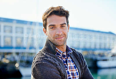 Buy stock photo Shot of a handsome young man spending a day outdoors