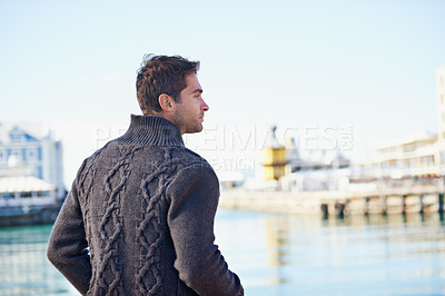 Buy stock photo Man, standing and think with ocean for idea and trip for travel or relax in urban or outdoor for fresh air. Young person and looking for view and harbor for break, wondering and pensive on vacation