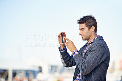 Buy stock photo Man, phone and photography at harbor, outdoor and space for mockup with creativity on urban sidewalk. Person, photographer and smartphone for vacation, profile picture or memory on road in Cape Town