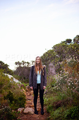 Buy stock photo Woman, hiking and smile in nature for portrait on path with fitness, outdoor or adventure on holiday. Girl, person and happy for trekking in bush, hill and rocks for journey on vacation in Cape Town