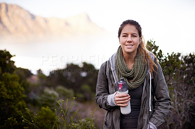 Buy stock photo Woman, hiking and portrait in nature with bottle for water with fitness, hydration or smile on adventure. Girl, person and trekking in bush, mountains and rocks for journey on vacation in Cape Town