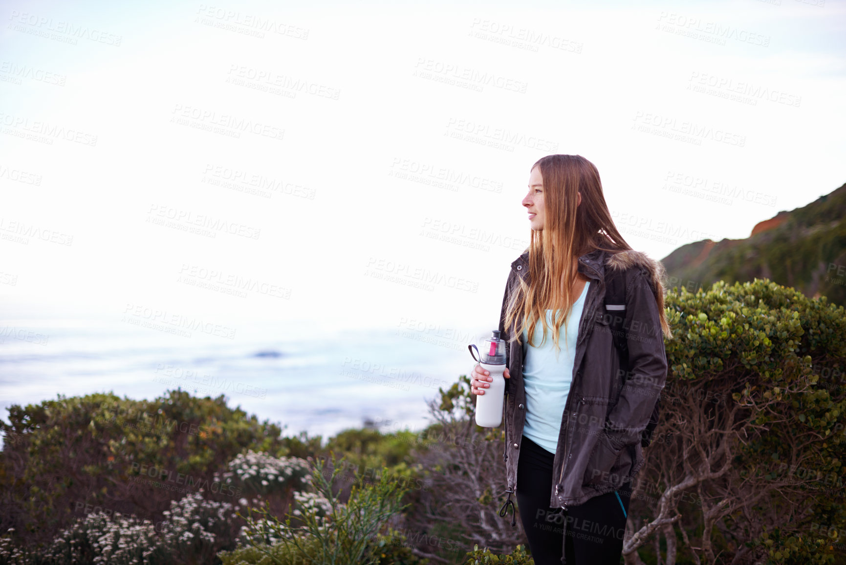 Buy stock photo Woman, hiking and outdoor with bottle, water and space for mockup with fitness, vision or memory on adventure. Girl, person and hydration in bush, mountains and path for journey by ocean in Cape Town