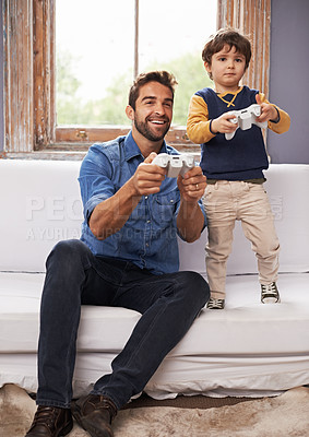 Buy stock photo Family, father and son on a sofa, video game and competition with bonding, loving or relax at home. Parent, happy dad or boy on a couch, playing and gamers in the living room, happiness or connection