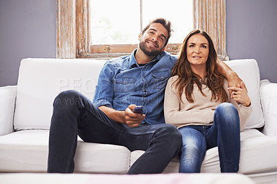 Buy stock photo Couple, watching tv on sofa and relax together in living room with streaming service, trust and hug for bonding. Man, woman with Netflix and chill on the weekend, marriage and remote for television
