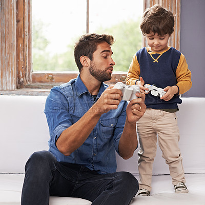 Buy stock photo Dad, child or controller on sofa to relax, learning or video game as esports, tech or living room. Man, kid or remote on couch to rest, teach or gaming as virtual, competition or bonding together