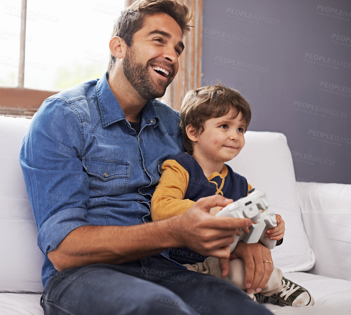 Buy stock photo Happy, father and son with controller, video game and happiness at home, bonding and quality time. Family, dad or male child on a couch, loving or playing online games, joy and technology in a lounge