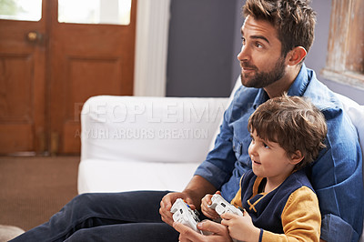 Buy stock photo Video games, father and son on a sofa, entertainment and relax at home, kid and fun in the lounge.  Family, dad or boy with parent, male child and controller on a couch,  happiness or multiplayer app
