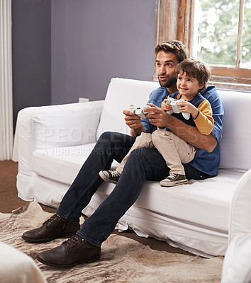 Buy stock photo Love, father and son on a couch, video game and bonding at home, happiness and relax together. Family, dad and boy with parent, kid and male child playing online, smile and loving with cyber gamer