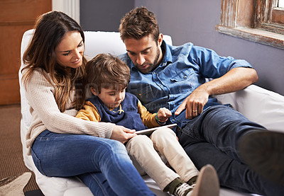 Buy stock photo Shot of a loving family using a digital tablet together