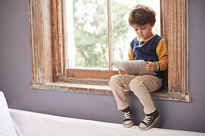 Buy stock photo Home, tablet and serious kid on internet, app or game on website for learning by windowsill. Technology, child and boy in house for education, relax and watch cartoon online on digital electronics