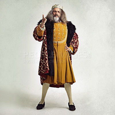 Buy stock photo Portrait, king and crown with a man leader in studio on a gray background during the renaissance or victorian period. Leadership, history or vintage with a male monarch standing hand on hip for power
