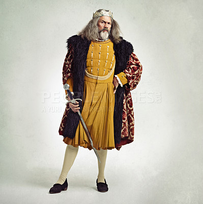 Buy stock photo Studio shot of a richly garbed king holding a sword