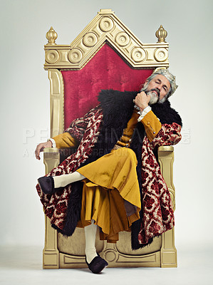 Buy stock photo King, royalty and man on throne in studio isolated on a gray background. Victorian monarch, medieval portrait and mature male, leader and regal ruler with crown sitting on royal seat and thinking.