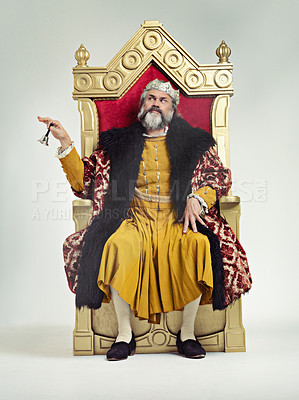 Buy stock photo Studio shot of a richly garbed king sitting on a throne