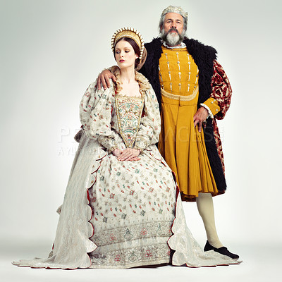 Buy stock photo King, queen and crown with a couple in studio on a gray background during the renaissance or victorian period. Royalty, history and vintage with a man and woman monarch, leader or ruler of a kingdom