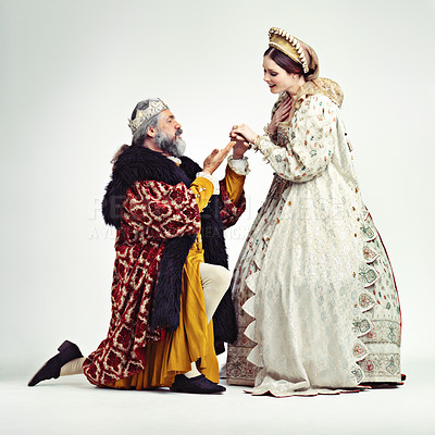 Buy stock photo Studio shot of a king proposing to a royal lady
