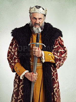 Buy stock photo King, angry and portrait of man with sword in studio isolated on a gray background. Victorian royalty, evil and mad senior male, annoyed ruler and frustrated leader holding bloody blade after battle.