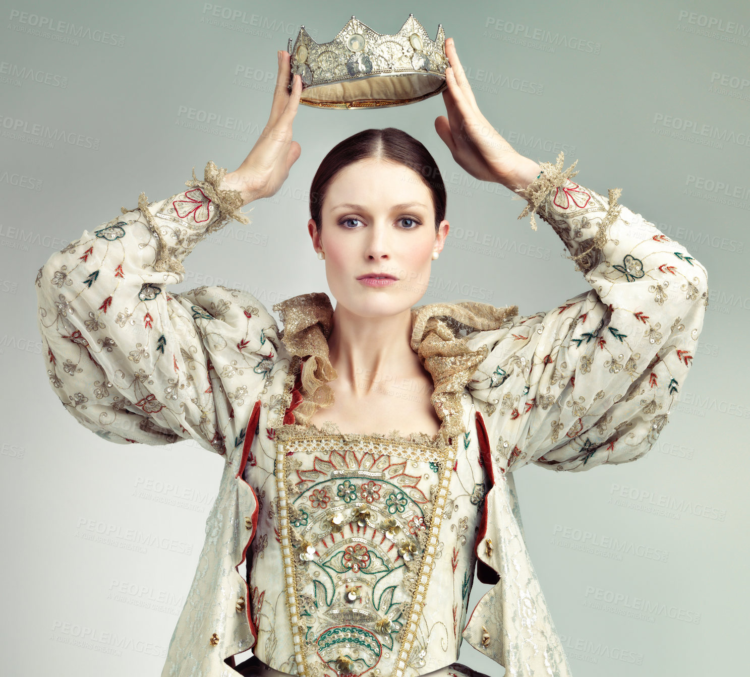 Buy stock photo Shot of queen holding a crown over her head