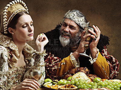 Buy stock photo King, queen and royalty with feast and wine in banquet hall for fine dinning for tradition or culture in palace. Monarch, sovereign and together with buffet for luxury, bored and vintage with goblet.