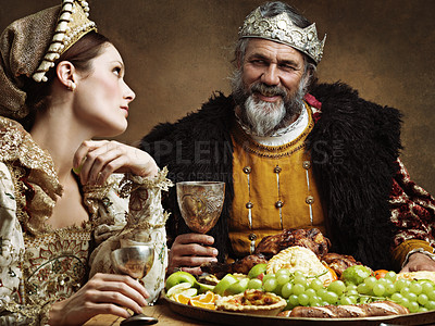 Buy stock photo King, queen and royalty with buffet and wine in banquet hall for fine dinning for tradition or culture in palace. Monarch, sovereign and together with feast for luxury, bored and vintage with goblet.