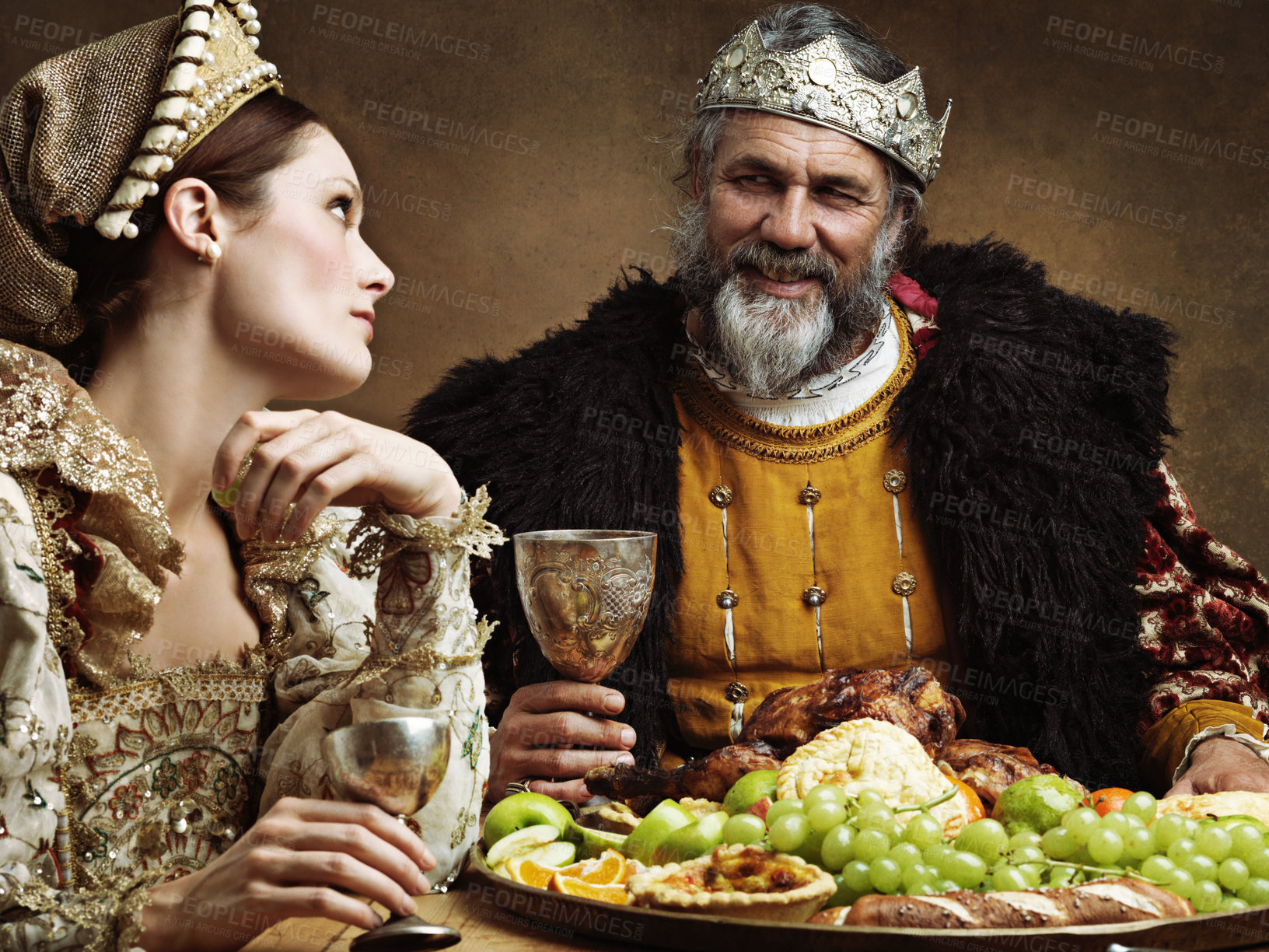 Buy stock photo King, queen and royalty with buffet and wine in banquet hall for fine dinning for tradition or culture in palace. Monarch, sovereign and together with feast for luxury, bored and vintage with goblet.