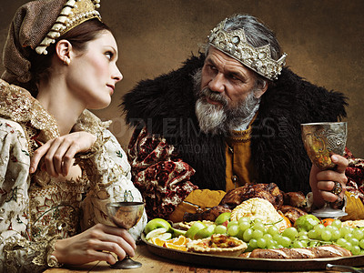 Buy stock photo King, queen and together with feast and wine in banquet hall for fine dinning for tradition or culture in palace. Monarch, sovereign and royalty with buffet for luxury, bored and vintage with goblet.