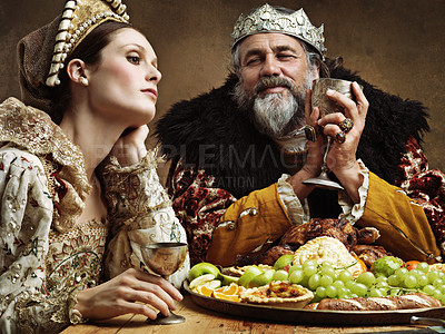 Buy stock photo King, queen and feast with wine at table for fine dinning in royal banquet, vintage and majestic with crown. Monarch, husband and bored together with alcohol and buffet for formal celebration