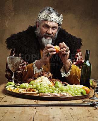 Buy stock photo A mature king feasting alone in a banquet hall