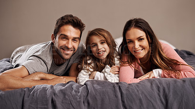 Buy stock photo Parents, girl and portrait in bedroom to relax in home for weekend break, family time and happiness for bonding. Father, mother and child comfy or cozy together on Easter Sunday morning for love.