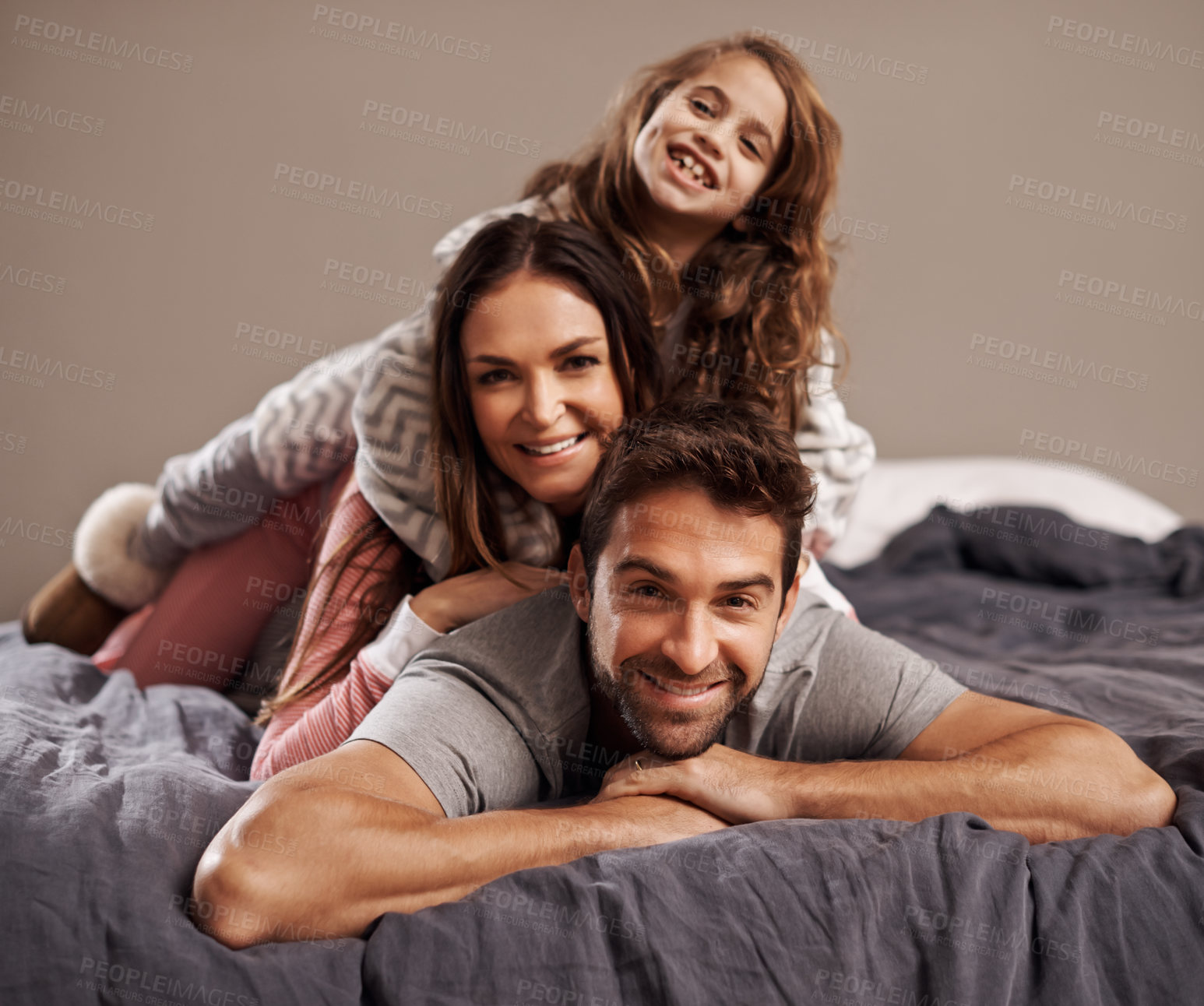 Buy stock photo Parents, child and portrait in bedroom to relax in home for weekend break, family time and happiness for bonding. Father, mother and girl comfy or cozy together on Easter Sunday morning for love.