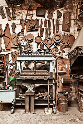 Buy stock photo Workshop, metal tools and forge with wall background for industry, vintage manufacturing and development. Retro factory, workspace and industrial for steel, iron and production for craftsmanship