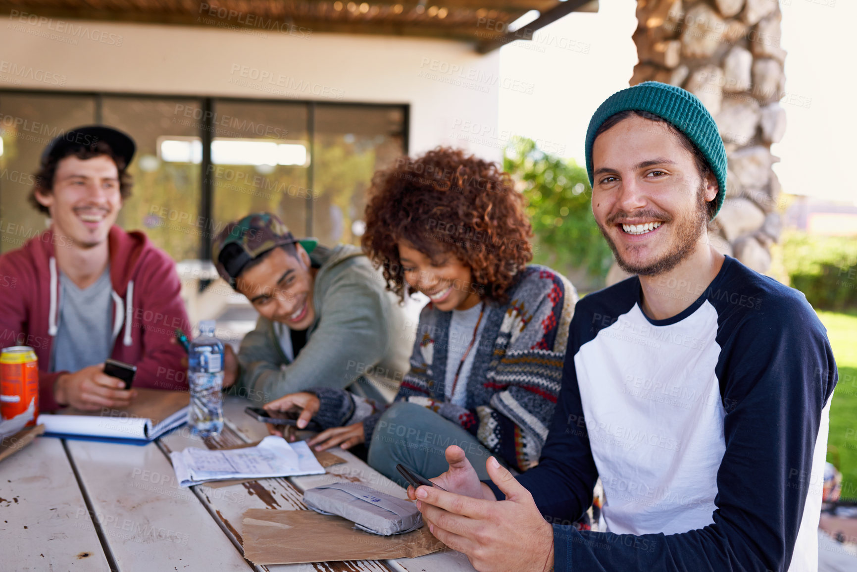 Buy stock photo Friends, group and outdoor lunch or students together on backyard patio for bonding, notes or connection. Men, women and smile with beverages at table for community gathering, communication or snack