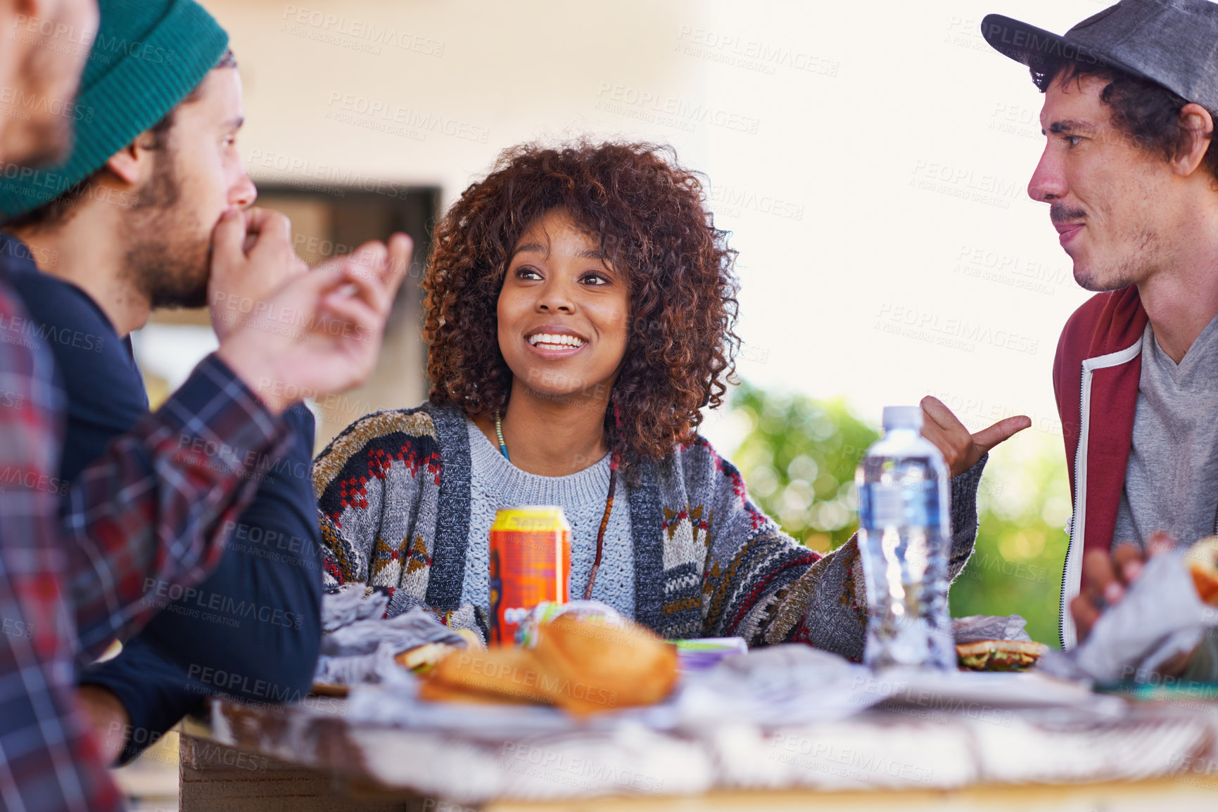 Buy stock photo Friends, group and outdoor talking for eating lunch together on backyard patio for bonding, relaxing or connection. Men, women and smile with beverages for community gathering, communication or snack