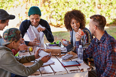 Buy stock photo A group of friends around an outdoor table