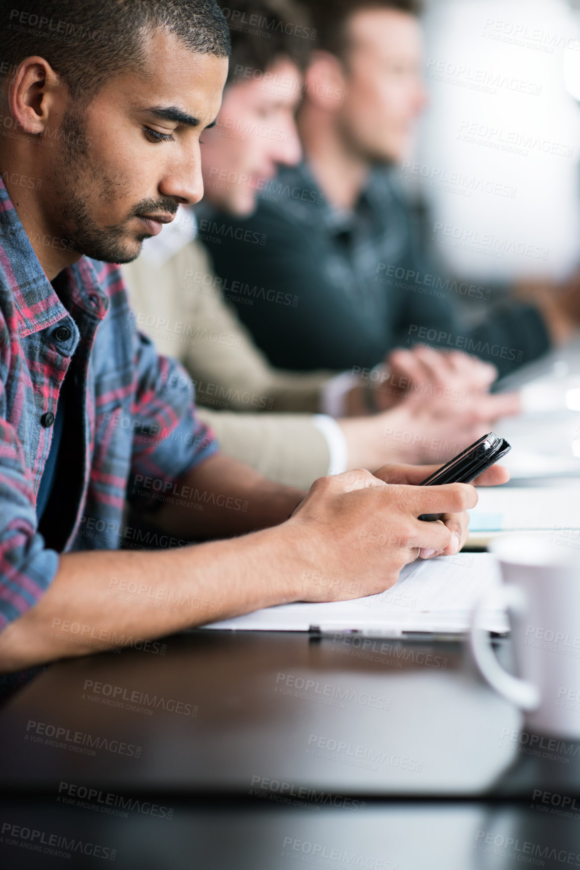 Buy stock photo Businessman, graphic designer and mobile in meeting at office with teamwork, collaboration and cooperation with colleagues. Professional, group or person with notes on phone for startup project