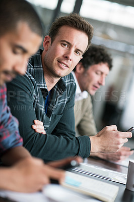 Buy stock photo Creative, businessman and portrait in meeting with phone at office for teamwork, collaboration and cooperation. Professional, group and man with notes on smartphone for planning, project or research
