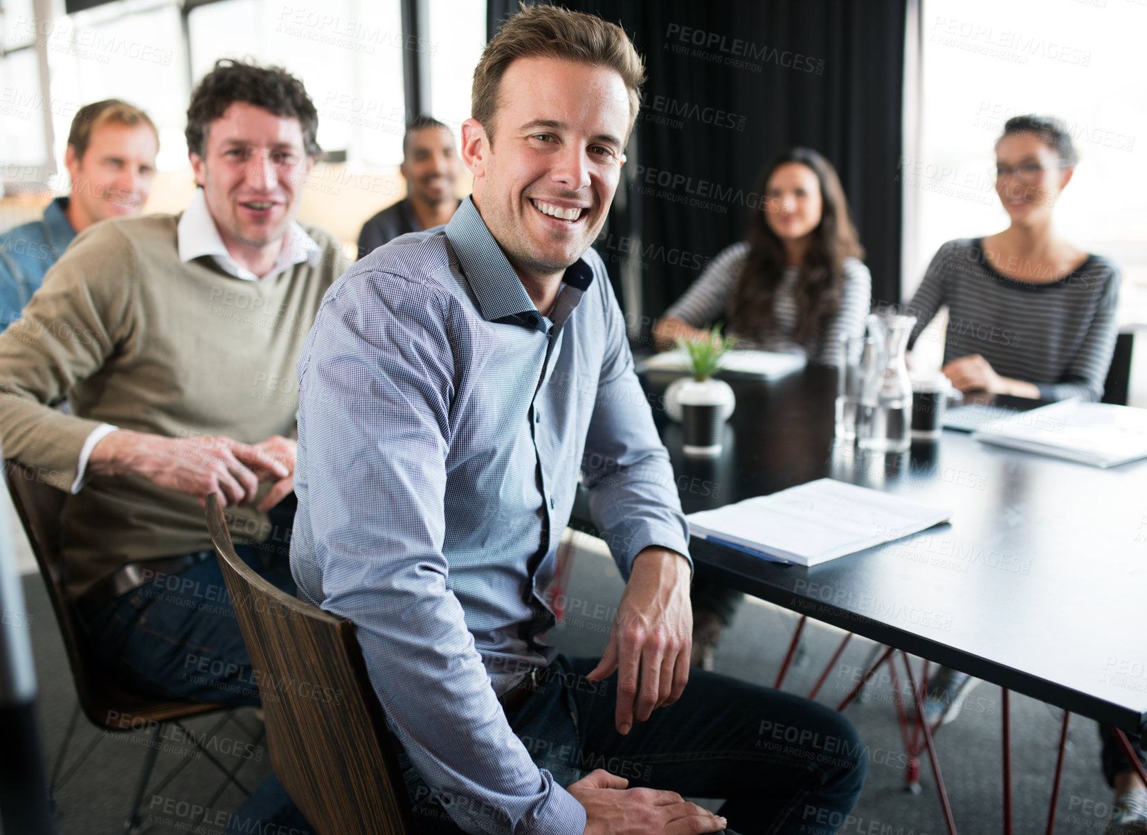 Buy stock photo Happy, portrait and businessman in meeting at office with teamwork, collaboration and cooperation on project. Professional, group and man with notes for planning or agenda for London company progress