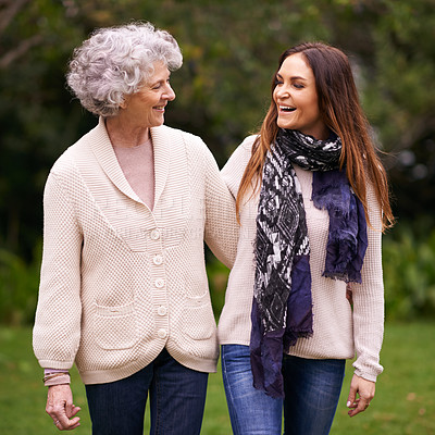 Buy stock photo Smile, park and woman with elderly mother together on a outdoor vacation or holiday bonding in happiness. Retirement, women and young happy female person in conversation and laughing with mom