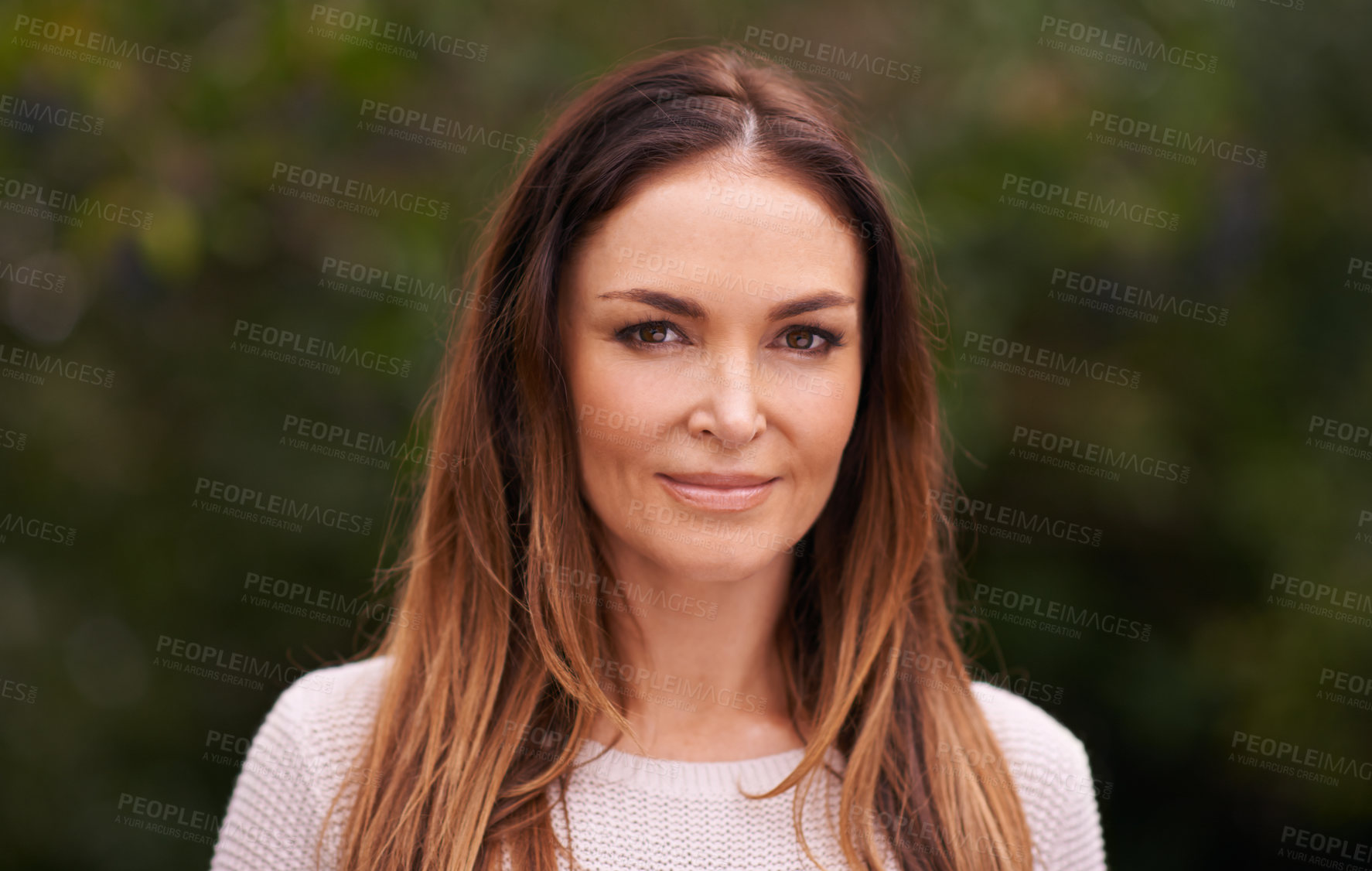 Buy stock photo Cropped portrait of an attractive woman standing outside