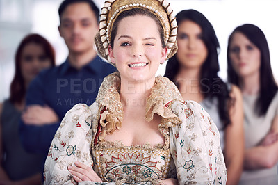 Buy stock photo Shot of a businesswoman dressed as a queen with her colleagues in the background