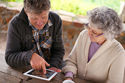 Buy stock photo Senior couple, tablet or app to search, internet or contact on social media, blog or relax on patio. Man, woman or touch screen to browse, learn or download of meme, news or ebook on web app for fun