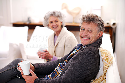 Buy stock photo Portrait, senior couple or coffee to relax on sofa as bonding together in living room in retirement. Older man, woman or tea on couch as morning chat on happiness, love or commitment in marriage